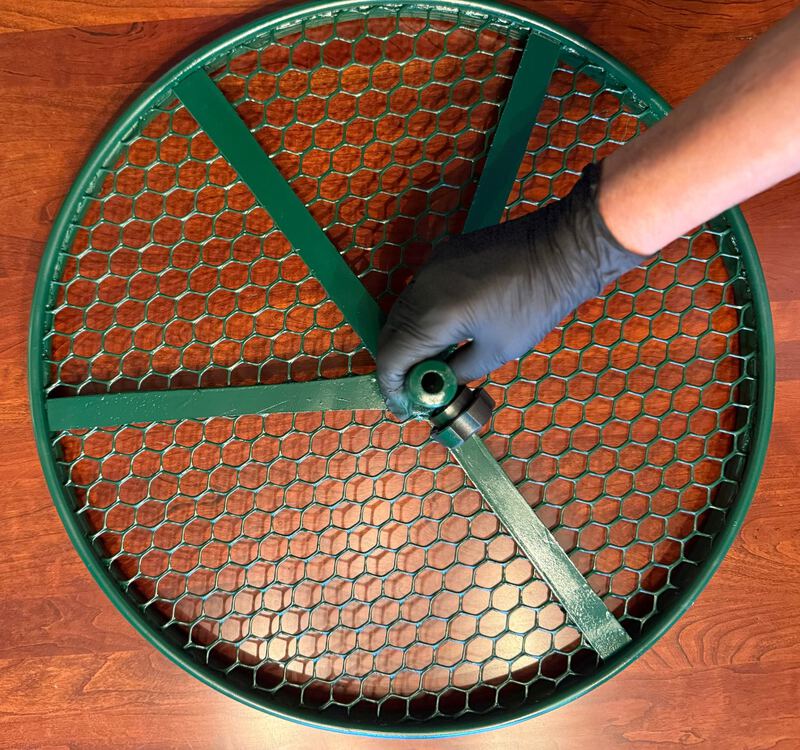 20-inch Cola Cultivator held by its hub on a wood table