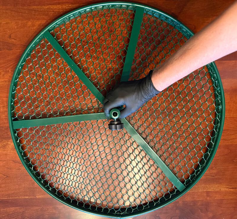24-inch Cola Cultivator held by its hub on a wood table